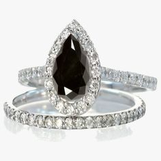 two wedding rings with black and white diamonds