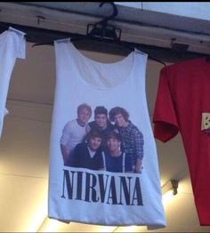 two t - shirts hanging on a clothesline with the name nirvana printed on them