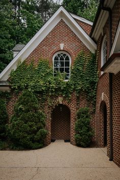 an old brick house with ivy growing on it's wall and arched doorways