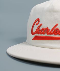 Our Sporty Charleston Brushed Snapback features a perfectly worn in feel, embroidered and woven patch details, and adjustable plastic snapback closure.Made from washed 100% cotton twill fabric Adjustable plastic snapback closure Retro Cotton Snapback Hat With Logo Patch, Vintage Cotton Snapback Hat With Embroidered Logo, Flat Brim Cotton Hat With Letter Patch, Vintage White Cotton Dad Hat, Cotton Flat Brim Hat With Letter Patch, Cotton Snapback Trucker Hat With Embroidered Logo, Cotton Snapback Hat With Embroidered Patch And Flat Brim, Cotton Trucker Hat With Embroidered Logo Flat Brim, Cotton 5-panel Snapback Hat With Embroidered Logo