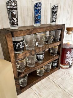 a wooden shelf with glasses and bottles on it