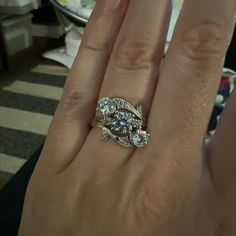 a woman's hand with a diamond ring on it