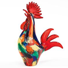 a colorful rooster figurine sitting on top of a table