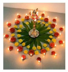 an arrangement of flowers and candles arranged in the shape of a kaleikabob