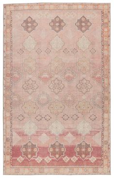 an antique rug with many different colors and patterns on the carpet, including pinks, browns