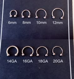 four different types of piercings are shown on a black sheet with white dots in them