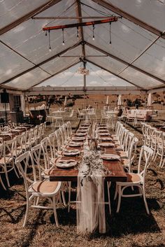 tables and chairs are set up under a tent