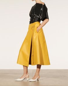 Introducing our Women's Genuine Lambskin Leather Midi Skirt, a stunning piece designed for the fashion-forward individual. This unique skirt features a string closure and front-open wrap design, inspired by the elegance of Zara's designs. Crafted from premium genuine lambskin leather, this yellow skirt is custom-made to plus sizes, ensuring a perfect fit for all body types. Versatile and stylish, it's suitable for all-season wear and available in a range of vibrant colors. Material: Crafted from genuine lambskin leather, this skirt offers luxurious quality and durability, ensuring long-lasting comfort and style. Design: With its midi length and front-open wrap design secured by a string closure, this skirt exudes sophistication and modernity. The vibrant yellow color adds a pop of color to Yellow Leather Skirt, Leather Wrap Skirt, Unique Skirt, Unique Skirts, Leather Midi Skirt, Yellow Skirt, Leather Pocket, Yellow Leather, Skirts With Pockets