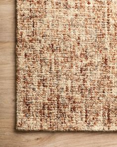 an area rug with brown and white colors on top of a wooden flooring surface