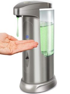 a person holding their hand out towards a water dispenser with green liquid in it