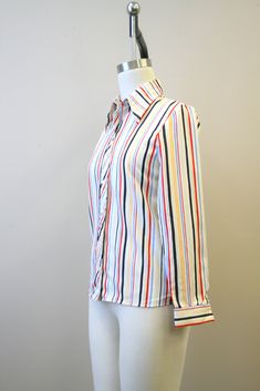 "Description: 1980s white blouse with red, blue, and black stripes. Polyester. Button front with long sleeves. Condition: In great condition, with no holes or stains. Designer: You-nique Stated Size: 7 Measurements: Armpit to armpit: 18\" Shoulder to shoulder: 15\" Sleeve length: 22.75\" Overall length: 25.5\" Waist: up to 31\" ---> If you need an order shipped by a particular date or shipped via a quicker method, please ask PRIOR to purchase to see if we can accommodate that request. Visit t White Blouse, Striped Blouse, Blue And Black, Black Stripes, Red Blue, Blouses For Women, Overalls, Blouses, Stripes