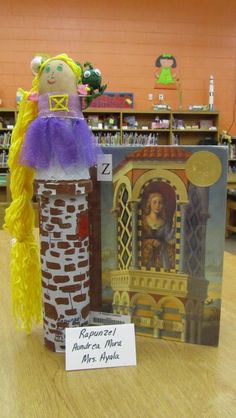 a cardboard doll is standing next to a book in a library with other books on the shelves