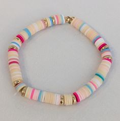 This bracelet is perfect for your next beach trip its got the colors of sea shells, the ocean, and the beautiful sunset you can watch from your luxurious beach house. Bohemian Pink Jewelry For Beach Party, Pink Jewelry For Beach Party, Pink Jewelry For Beach Party Season, Pink Beach Bracelets For Beach Season, Playful Heishi Beads Bracelets For Beach, Pink Beachy Bracelets For Beach Season, Pink Beaded Bracelets For Beach Season Vacation, Pink Bracelets For Beach Season Vacation, Pink Bracelets For Beach Vacation