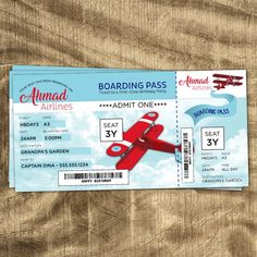 a red plane ticket sitting on top of a wooden table