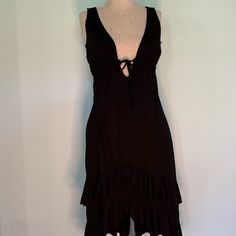 Nwt Black Knee Length Sleeveless Dress With Very Deep V Neck. Has Ruffled Bottom. Flirty Sleeveless Midi Dress With Tie Back, Flirty Sleeveless Tie-back Midi Dress, Tie-back Sleeveless Dress For Date Night, Black Sleeveless Ruffled Summer Dress, Black Sleeveless Summer Dress With Ruffles, Black Summer Sleeveless Dress With Ruffles, Sleeveless Sundress Midi Dress For Night Out, Sleeveless Tie-back Maxi Dress For Night Out, Sleeveless Black Midi Dress With Tie Back