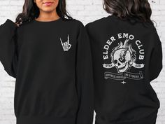 "*This shirt has a design on the FRONT & BACK* The Elder Emo Club T-shirt is the perfect Pop Punk Shirt for anyone who loves emo music and culture. With a striking skull design, this Emo Concert Shirt is the perfect way to show off your love for the genre. This Shirt for Elder Emo proudly displays the \"Emo Forever\" and \"It Was Never A Phase\" slogans, making it clear that your love for emo is here to stay. The Stay Sad Club Shirt is made with high-quality materials, ensuring both comfort and durability. Whether you're heading to a concert or just want to show off your love for emo, the Elder Emo T-shirt is a must-have. Get your hands on this stylish and versatile Emo Concert Shirt today and join the club! Ideal for any situation, a unisex heavy blend crewneck sweatshirt is pure comfort. Emo Crew Neck Top For Fan Merchandise, Casual Concert Tops With Front And Back Print, Casual Tops With Front And Back Print For Concert, Concert Band Merch Tops With Front And Back Print, Punk Summer Outfits, Emo Concert, Emo Party, Punk Summer, Elder Emo