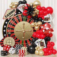 a casino wheel surrounded by balloons and dices