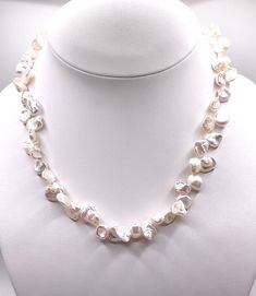 Genuine freshwater Keishi pearl necklace. Biwa pearls are unusually shaped cultured pearls that come from the freshwater mussels, Japan. They have been produced since the 1930s and made pearl ownership much more attainable for people who could not afford natural and cultured saltwater pearls. Dress it up or wear it casually. Either way, you will be a hit! Elegant Baroque Pearl Shell Necklace As Gift, Elegant Shell Necklace With Baroque Pearl Drop, Elegant Pearl Pendant Shell Necklace, Elegant Pearl White Shell Necklace With Pearl Drop, Elegant White Shell Necklace With Pearl Charm, Elegant Pearl Shell Necklace As A Gift, Elegant Pearl Shell Necklace For Gift, Formal White Mother Of Pearl Necklaces, Elegant White Shell Necklace For Wedding