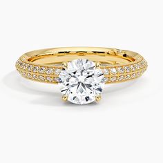 a yellow gold engagement ring with diamonds on the side