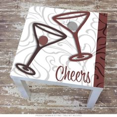 a wooden table topped with a paper cut out of a wine glass on top of it