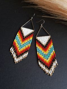 Embrace the spirit of the wild west with these Western Earrings, where the art of seed bead craft meets the boldness of frontier style. These Beaded Earrings feature a fringe design that moves with a rustic charm, complementing the boldness of their long, striking silhouette. Perfect for any Boho Chic jewelry lover, these earrings make a statement of independence and style, channeling the adventurous vibe of the untamed west. Whether you're heading to a country music festival or a night out, these Bold Long Earrings are the perfect accessory to complete your look. Dimensions: Approximately 4.5in / 11cm long with the hooks I am pleased to inform you that all my items are shipped with Royal Mail tracking! This ensures that you can monitor the progress of your shipment every step of the way. Southwestern Beaded Earrings With Tassels For Festival, Southwestern Fringe Dangle Jewelry, Southwestern Fringe Earrings With Round Beads, Southwestern Fringe Jewelry With Round Beads, Southwestern Fringe Earrings For Festivals, Festival Beaded Fringe Tassel Earrings, Festival Beaded Fringe Earrings With Round Beads, Festival Tassel Earrings With Beaded Fringe, Beaded Fringe Earrings With Round Beads For Festivals