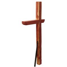 a wooden cross that is standing up against a white background