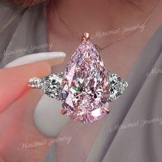 Handmade Unique Celebrity Style Large Three-Stone Pink Pear Shaped Engagement Ring,wedding ring with 6.6 CT Luxury pear Moissanite → Occasions: Engagement & Wedding DESCRIPTION  -------------------- STYLE                                       :Three stone *Moissanite Details  Stone                                        :Moissanite - High Quality                          Main Stone                            :Pear  (Pink Moissanite) Size (mm)                               :16*10 Carat Weight Pink Pear Engagement Ring, Pink Pear Ring, Pink Pear Diamond Ring, Huge Wedding Rings, Engagement Ring Big, Pink Stone Engagement Rings, Large Engagement Rings, Huge Wedding, Pear Shaped Engagement Ring