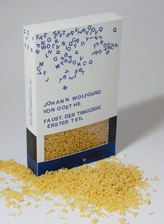 an open box of rice sitting on top of a pile of shredded yellow kernels