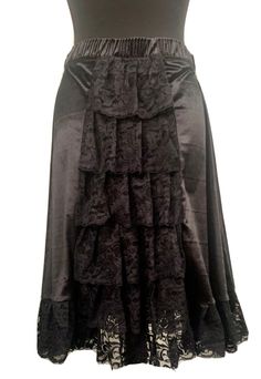 "This is a Victorian style gothic steampunk skirt with an elasticated waistband . This is a black midi length velvet mix skirt .can be worn with a corset . It has black lace trim  to the boarder. It also has ruffles of lace towards the back, tiered please see photos. It's a free size ,waist 25 before stretch . Stretches to approx 38\".please refer to photo for length . This is a midi  Available in 3 colour ways:- Black Red Purple Thank you for looking" Steampunk Tiered Skirt For Costume Party, Gothic Long Ruffled Skirt, Gothic Long Ruffled Skirt Bottoms, Gothic Tiered Skirt For Halloween, Gothic Skirt With Lace Trim, Gothic Tiered Skirt For Costume, Gothic Black Skirt With Attached Cancan, Steampunk Ruffled Skirt For Halloween, Steampunk Ruffled Skirt For Party