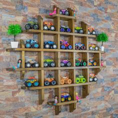 a wooden shelf filled with lots of toy trucks on top of it's sides