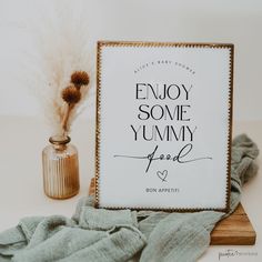 a sign that says enjoy some yummy joy next to a vase with dried flowers