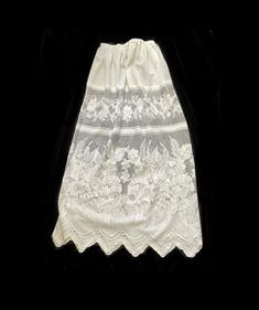 White lace fabric under slip. Sheer fabric Skirt or Slip with adjustable elastic waist. Extra Long Large size Slip measurement  28 inches wide elastic adjustable waist  48  inches long from top of of waist to bottom of ruffles.  36 inches long floral lace ruffle  Hand spot wash only.  Hang dry. Style 1 short slip  30 inches long  28 inches wide elastic waist  Style 2  26 inches long  28 inches wide elastic waist Lace Skirt With Lace Work, Spring Wedding Skirt With Lace Patchwork, Fitted Delicate Lace Skirt For Summer, Long Lace Skirt With Lace Patchwork, Long Lace Skirt With Patchwork, Fitted Summer Skirt With Delicate Lace, Spring Lace Skirt With Contrast Lace, Long Skirt With Lace Patchwork, Summer Fitted Skirt With Delicate Lace