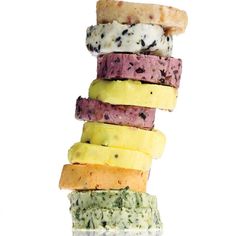 a stack of different types of food on top of each other in front of a white background