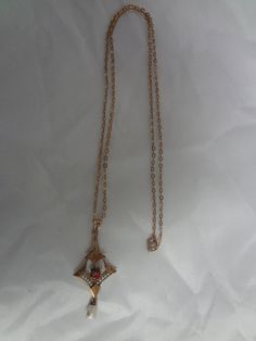 "PRE-OWNED Beautiful 1800's Victorian necklace with a ruby in the center, seed pearl outline and a dangle pearl at the bottom. It is 10K gold and in great condition, a few scratches, but not deep or serious. The necklace looks great for its age. The length of the chain is 16\". The pendant itself is 1 1/4\" long x 5/8\" wide. If you have any questions regarding this item or pricing, please feel free to contact us :) -------------------------------------- Please be 100% sure of your purchase befo Victorian Necklace, Seed Pearl, Saint Louis, 10k Gold, Pearl Necklace, Ruby, Chain Necklace, Gold Necklace, Yellow Gold