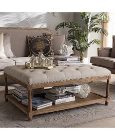 a living room filled with furniture and a coffee table in front of a couch on top of a rug