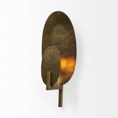 two large metal plates mounted to the side of a wall, one with an orange light in it