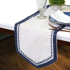 a white table topped with a blue and white place setting