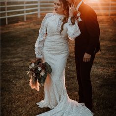 a bride and groom posing for a photo in front of a white fence at sunset