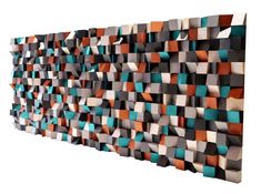 an abstract wall sculpture made out of different colored blocks