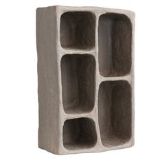 a concrete block with four compartments on each side and one section open to show the inside