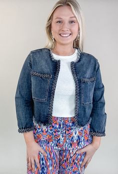 Catch everyone's eye with this fab denim jacket featuring braid details! Its cropped length and frayed hem make it one-of-a-kind and the perfect piece to complete any look! 19-1/2" HPS Collarless Frayed hem at neckline and waistline Braided trim Two front patch pockets Long sleeves with braided cuffs Emily is wearing a size medium Guinea Bissau, British Indian, Mozambique, Brunei, Patch Pocket, Make It, Denim Jacket, Braids, Trim