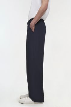 PRE-FALL 2024 MEN'S COLLECTION The Clyde Trouser in Midnight. These bottoms feature a flattering cinched waist that enhances your silhouette, while the pleated design adds a touch of elegance. The relaxed fit provides ease of movement, making them suitable for both work and casual outings. Fall 2024, Shop Swimwear, Pre Fall, Cinched Waist, Men's Collection, Midnight Blue, Trousers, Relaxed Fit, Size Small