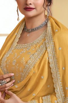 Get ready to turn heads with this Yellow Floral Pattern Embroidered Palazzo Suit Set! Expertly crafted with intricate embroidery, sequins, and resham thread work, this palazzo style salwar suit is the epitome of chic style. A matching bottom and dupatta finishes off the look with perfection. 3 piece with lining (Top, Bottom, Dupatta) Kameez chinon silk with heavy embroidery work Palazzo chinon silk with embroidery front and back Dupatta chinon silk with four side lace and all over embroidery wor Yellow Punjabi Suit, Phulkari Pants, Lucknowi Kurta, Plazzo Suits, Patiala Salwar Suits, All Over Embroidery, Lace Suit, Bridal Dupatta, Palazzo Style