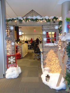 an office decorated for christmas with lights and decorations on the front door, along with fake snow