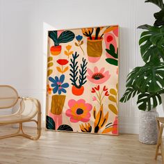 a painting on the wall next to a chair and potted plant