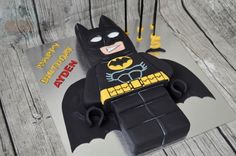 a birthday cake made to look like a lego batman with the bat symbol on it