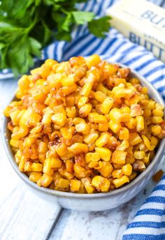 a bowl filled with corn on top of a table