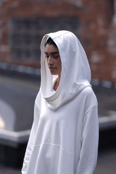 A masterwork in minimalist edge, our Firenze Hoodie is distinguished by a veil-like hood that brings the drama whether worn up or down. Crafted from light European sweatshirt fabric, she features an ultra-relaxed fit perfected by dropped shoulders and an elevated back that dips. Thumbholes keep the sleeves pinned to your wrist for a cozy, finishing touch. Firenze is as easy to maintain as to wear: effortless to clean, structured to last, doesn't pill. [SPLIT] Sam, in off white, in black and in o Fitness Wear Outfits, Sweatshirt Fabric, Hoodie Outfit, White Boots, The Drama, The A Team, Oversize Hoodie, Winter Looks, White Hoodie