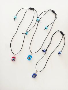 Evil eye chocker beaded necklace is adjustable. There are two round evil eye beads and a square evil eye bead. The Evil eye pendant and the two round evil eye beads are made of glass. Cord color(flos rope) is black. Evil eye pendant color options are red, light blue and dark blue. Closure is a macrame sliding knot. Lenght of the nazar necklace is between 14 in- 24in. Width of the murano glass evil eye pendant is 0.39 in(1 cm) For more evil eye necklaces, click the link below; https://www.etsy.co Adjustable Evil Eye Choker Necklace, Adjustable Evil Eye Amulet Necklace, Adjustable Spiritual Beaded Necklace With Evil Eye, Adjustable Spiritual Evil Eye Beaded Necklaces, Adjustable Evil Eye Spiritual Necklace, Adjustable Spiritual Evil Eye Beaded Necklace, Adjustable Spiritual Evil Eye Necklace, Turkish Necklace, Nazar Necklace