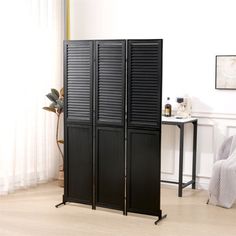 the room divider is made from black shutters